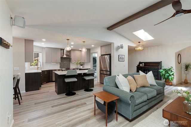 1361 E Old Ranch Rd, Allyn, WA 98524 - living room with a skylight, light wood-type flooring, recessed lighting, and stacked washer / dryer