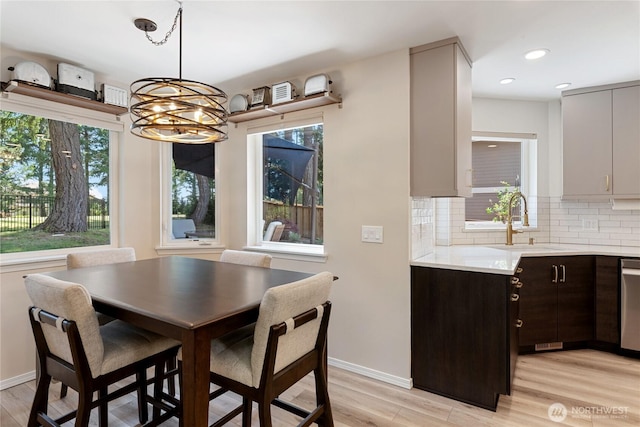 1361 E Old Ranch Rd, Allyn, WA 98524 - dining room with light wood-style floors, a chandelier, baseboards, and recessed lighting