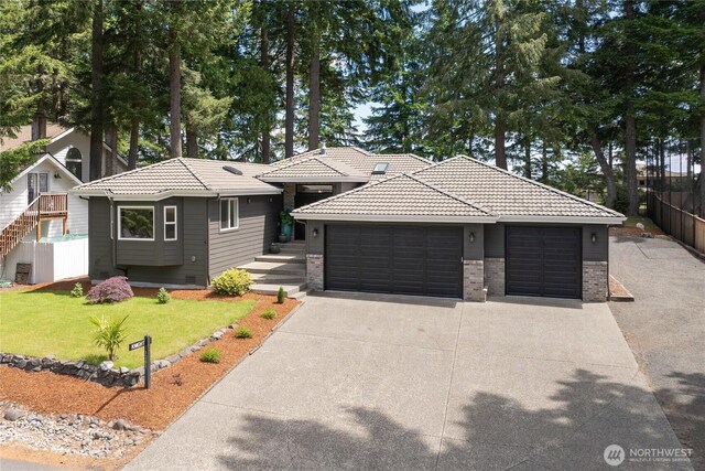 1361 E Old Ranch Rd, Allyn, WA 98524 - view of front of house featuring a tile roof, an attached garage, driveway, and brick siding