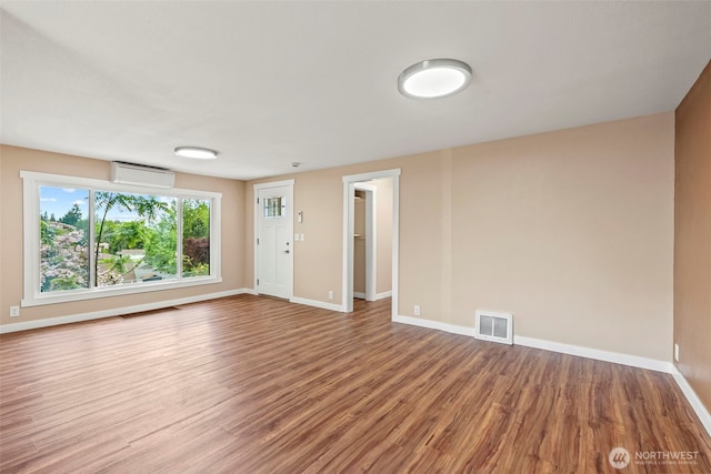2914 Columbia Heights Rd, Longview, WA 98632 - unfurnished room featuring wood finished floors, baseboards, and a wall mounted air conditioner