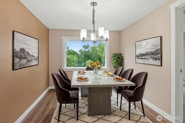 2914 Columbia Heights Rd, Longview, WA 98632 - dining space featuring wood finished floors, baseboards, and a chandelier