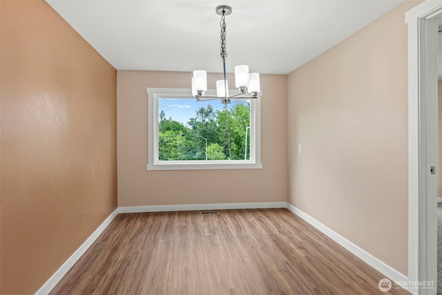 2914 Columbia Heights Rd, Longview, WA 98632 - unfurnished room featuring a chandelier, wood finished floors, and baseboards