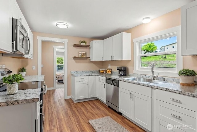 2914 Columbia Heights Rd, Longview, WA 98632 - kitchen featuring stainless steel appliances, a sink, open shelves, light wood-style flooring, and plenty of natural light