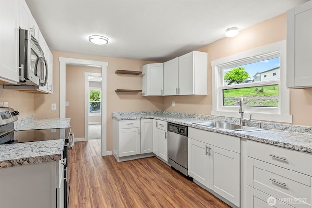 2914 Columbia Heights Rd, Longview, WA 98632 - kitchen with appliances with stainless steel finishes, open shelves, a sink, wood finished floors, and white cabinetry