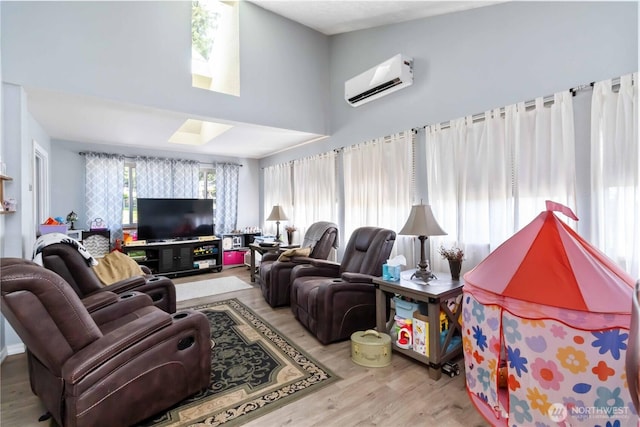 2337 W Castleman St, Longview, WA 98632 - living room with a wall mounted air conditioner, a skylight, wood finished floors, and a high ceiling