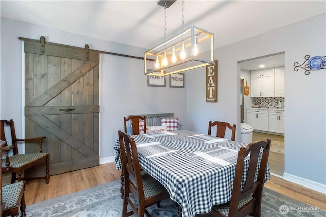 2337 W Castleman St, Longview, WA 98632 - dining area featuring light wood finished floors, baseboards, and a barn door