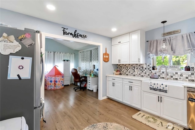 2337 W Castleman St, Longview, WA 98632 - kitchen with appliances with stainless steel finishes, white cabinetry, light countertops, decorative backsplash, and recessed lighting