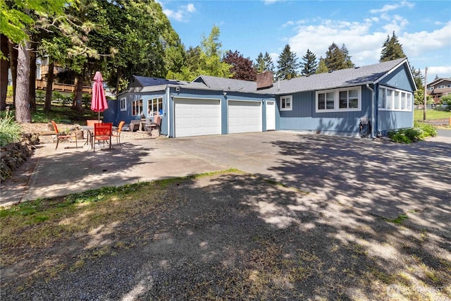 2337 W Castleman St, Longview, WA 98632 - ranch-style house featuring a garage, a chimney, and driveway