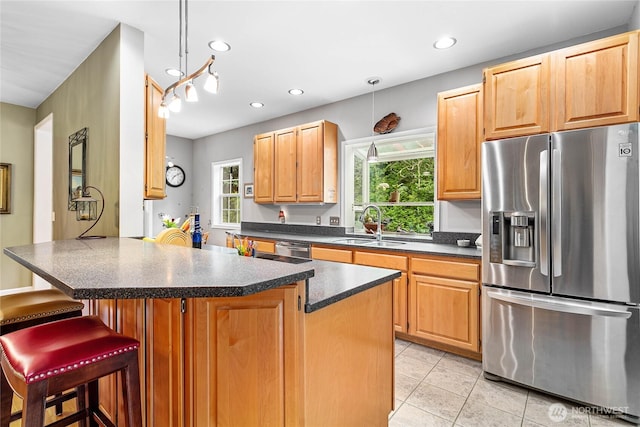 1933 Valleybrook Ln, Bellingham, WA 98229 - kitchen featuring appliances with stainless steel finishes, dark countertops, light tile patterned floors, healthy amount of natural light, and recessed lighting