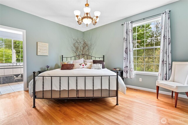 1933 Valleybrook Ln, Bellingham, WA 98229 - bedroom with wood finished floors, a chandelier, baseboards, and ensuite bathroom