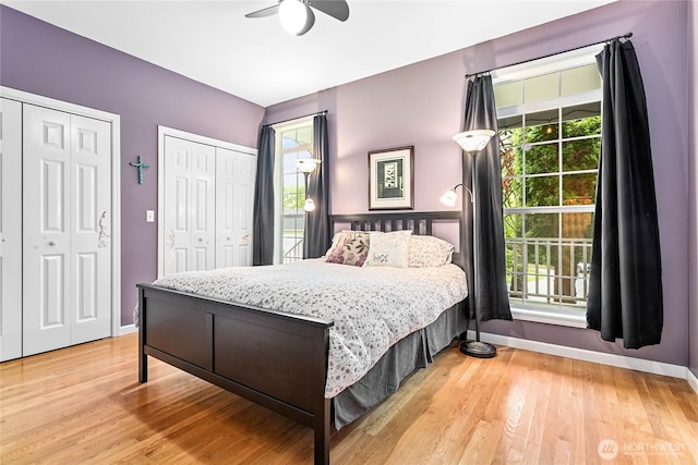 1933 Valleybrook Ln, Bellingham, WA 98229 - bedroom featuring two closets, baseboards, light wood-style floors, and ceiling fan