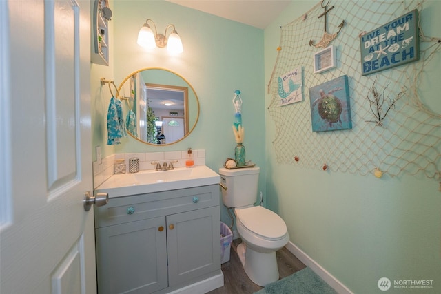 3217 289th St S, Roy, WA 98580 - bathroom featuring toilet, vanity, wood finished floors, and tasteful backsplash