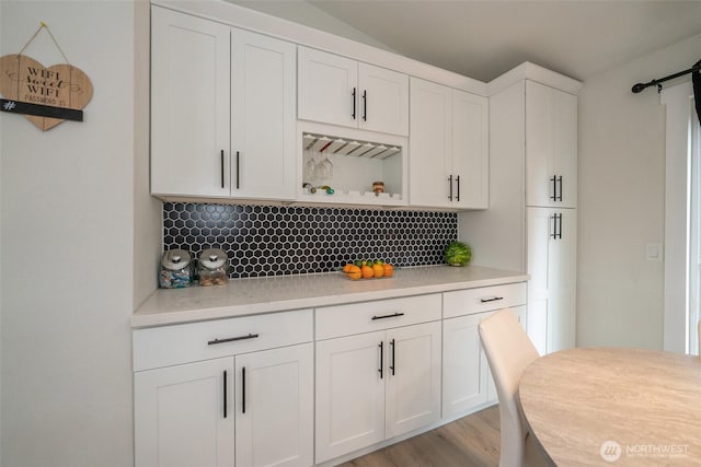 33137 35th Ave SW, Federal Way, WA 98023 - kitchen with decorative backsplash, light countertops, white cabinets, open shelves, and light wood-type flooring
