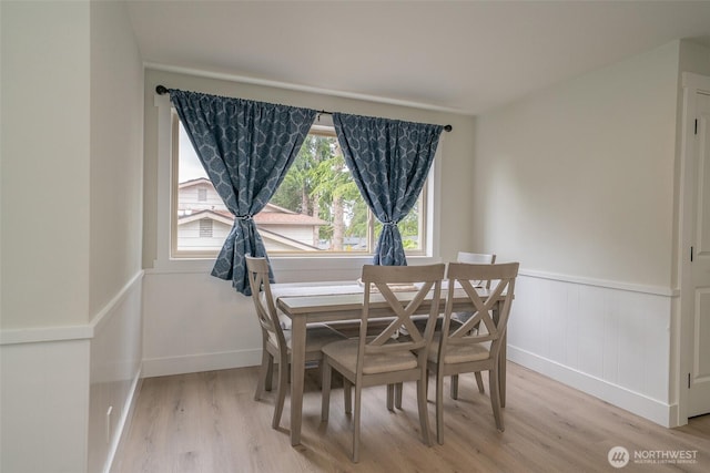 33137 35th Ave SW, Federal Way, WA 98023 - dining area featuring light wood-type flooring, a wainscoted wall, and baseboards