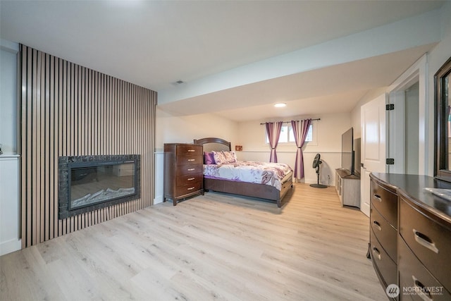 33137 35th Ave SW, Federal Way, WA 98023 - bedroom with light wood-style floors and a glass covered fireplace