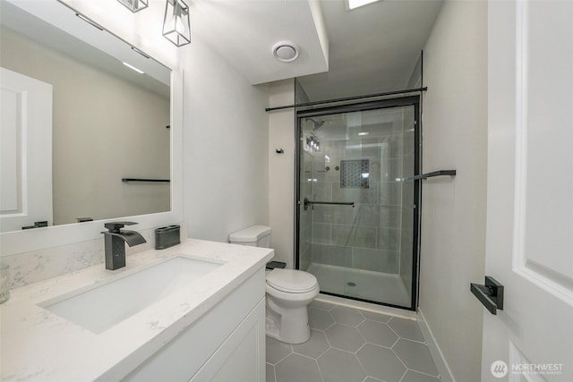 33137 35th Ave SW, Federal Way, WA 98023 - bathroom featuring toilet, a stall shower, vanity, tile patterned flooring, and baseboards