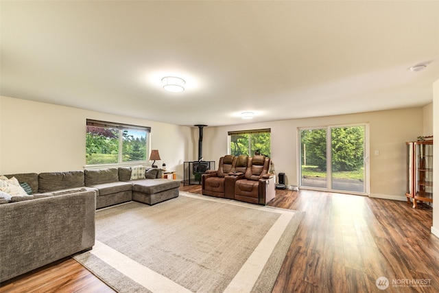 4718 252nd St NE, Arlington, WA 98223 - living area with wood finished floors, a wood stove, and baseboards