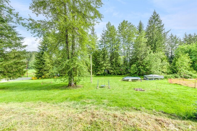 4718 252nd St NE, Arlington, WA 98223 - view of green lawn featuring a wooded view