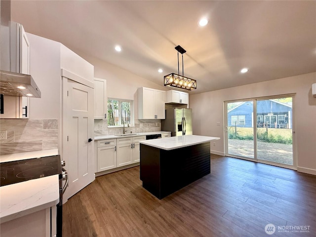 127 Olympic View Ave NE, Ocean Shores, WA 98569 - kitchen featuring stainless steel fridge with ice dispenser, electric range, dark wood-style floors, a kitchen island, and recessed lighting