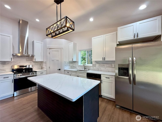 127 Olympic View Ave NE, Ocean Shores, WA 98569 - kitchen featuring stainless steel appliances, wall chimney exhaust hood, a center island, dark wood finished floors, and white cabinets