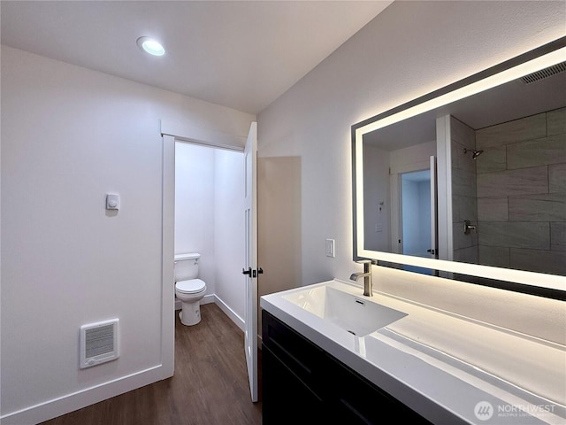 127 Olympic View Ave NE, Ocean Shores, WA 98569 - full bath featuring wood finished floors, heating unit, vanity, a tile shower, and recessed lighting