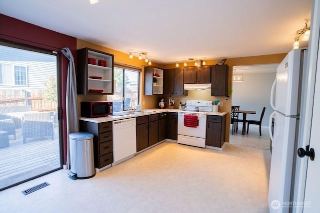 306 Belmont Ave, Moses Lake, WA 98837 - kitchen featuring white appliances, under cabinet range hood, open shelves, dark brown cabinetry, and light countertops