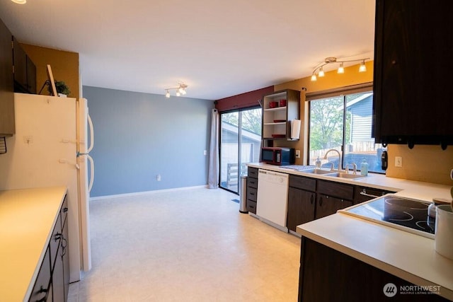 306 Belmont Ave, Moses Lake, WA 98837 - kitchen with white appliances, a sink, rail lighting, light countertops, and light flooring