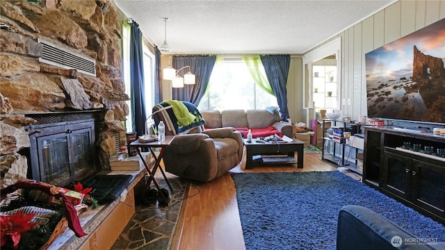 5008 N Visscher St, Tacoma, WA 98407 - living area with wood finished floors, a textured ceiling, and a fireplace