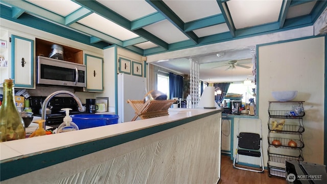 5008 N Visscher St, Tacoma, WA 98407 - interior space featuring stainless steel microwave, a ceiling fan, freestanding refrigerator, dark wood finished floors, and coffered ceiling