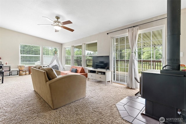 119 Oyler Way, Ethel, WA 98542 - living area with carpet, a wood stove, ceiling fan, and lofted ceiling