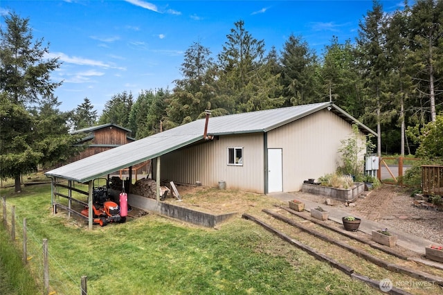 119 Oyler Way, Ethel, WA 98542 - view of side of home with an outbuilding, metal roof, an outdoor structure, and a carport