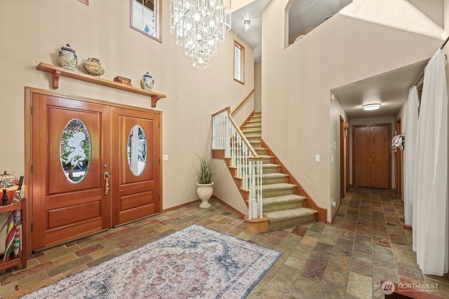5990 6th Ave SE, Lacey, WA 98503 - entrance foyer featuring stone tile flooring, a towering ceiling, baseboards, stairway, and a chandelier