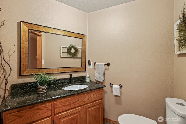 5990 6th Ave SE, Lacey, WA 98503 - half bathroom featuring toilet, vanity, and a textured ceiling
