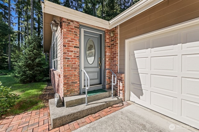 5990 6th Ave SE, Lacey, WA 98503 - property entrance featuring brick siding, an attached garage, and driveway