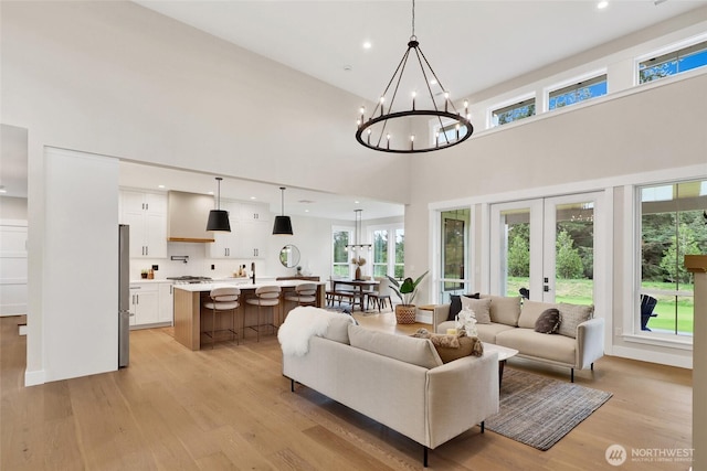 5712 Denali Ln, Bellingham, WA 98226 - living room featuring a chandelier, light wood-type flooring, a high ceiling, and recessed lighting