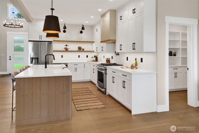 5712 Denali Ln, Bellingham, WA 98226 - kitchen with appliances with stainless steel finishes, decorative backsplash, wall chimney range hood, open shelves, and recessed lighting