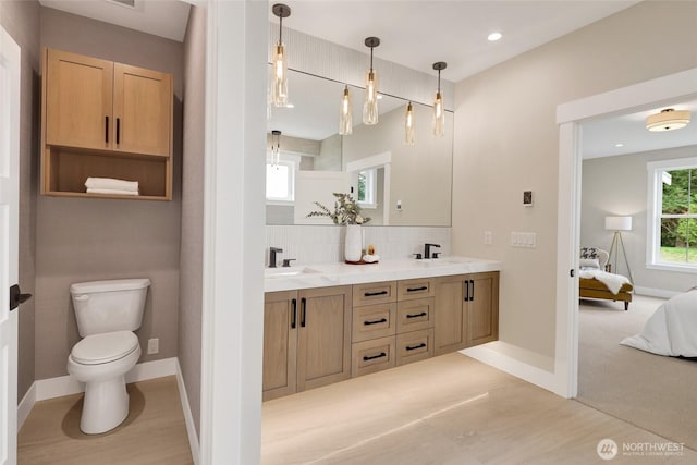 5712 Denali Ln, Bellingham, WA 98226 - full bathroom featuring ensuite bathroom, double vanity, tasteful backsplash, wood finished floors, and recessed lighting