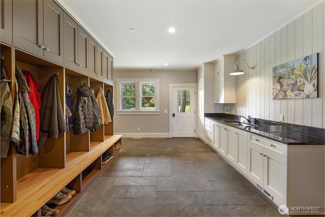 148 Yarrow Rd, Friday Harbor, WA 98250 - mudroom with dark stone finish floors, baseboards, a sink, wooden walls, and recessed lighting