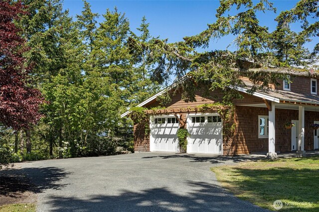 148 Yarrow Rd, Friday Harbor, WA 98250 - view of side of property featuring asphalt driveway and an attached garage