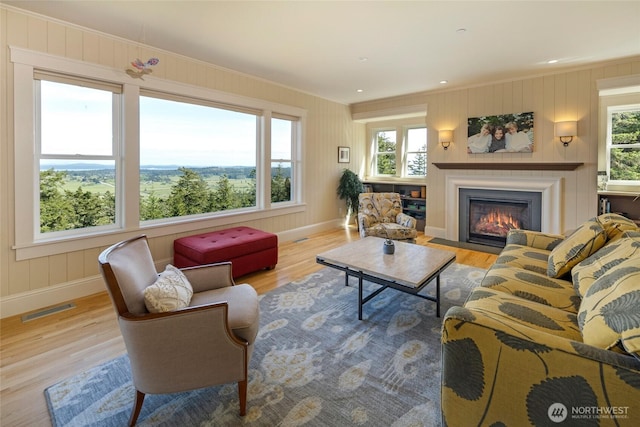 148 Yarrow Rd, Friday Harbor, WA 98250 - living room with plenty of natural light, wood finished floors, a fireplace with flush hearth, and ornamental molding