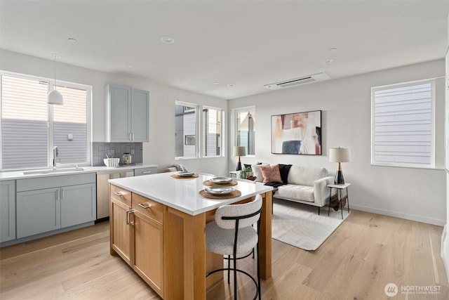 4519A Bagley Ave N, Seattle, WA 98103 - kitchen with dishwasher, light wood-style flooring, light countertops, tasteful backsplash, and recessed lighting