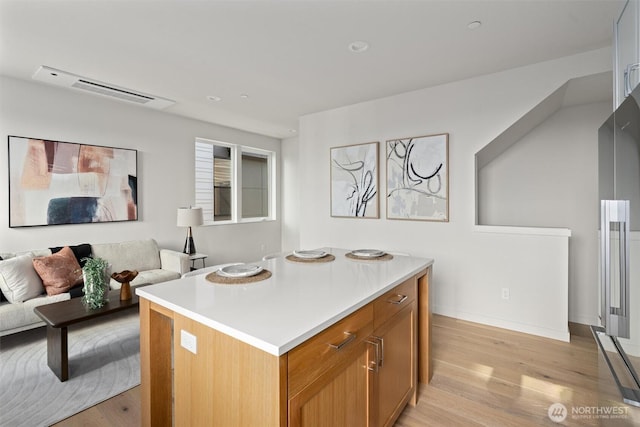 4519A Bagley Ave N, Seattle, WA 98103 - kitchen featuring light wood-type flooring, open floor plan, light countertops, a kitchen island, and recessed lighting