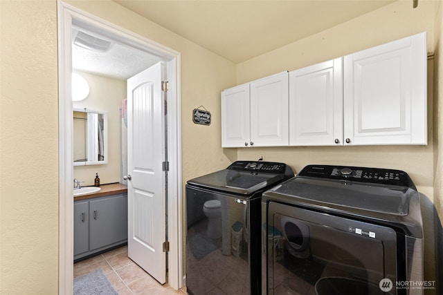 1291 Channel Ave SW, Ocean Shores, WA 98569 - washroom featuring cabinet space, independent washer and dryer, and light tile patterned floors