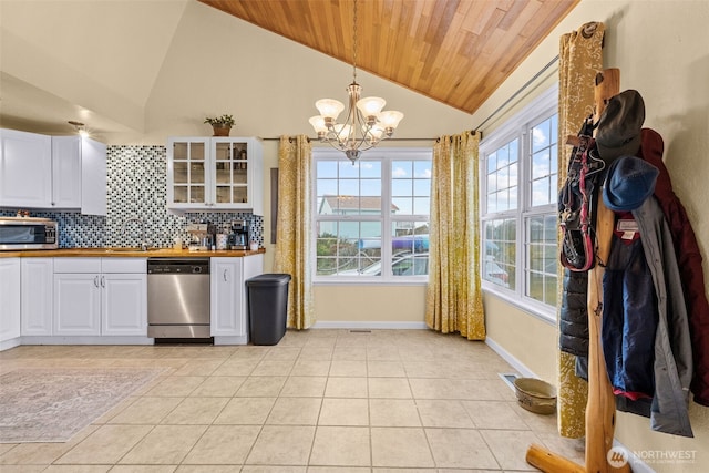 1291 Channel Ave SW, Ocean Shores, WA 98569 - kitchen with stainless steel appliances, wood ceiling, a chandelier, white cabinets, and light tile patterned flooring