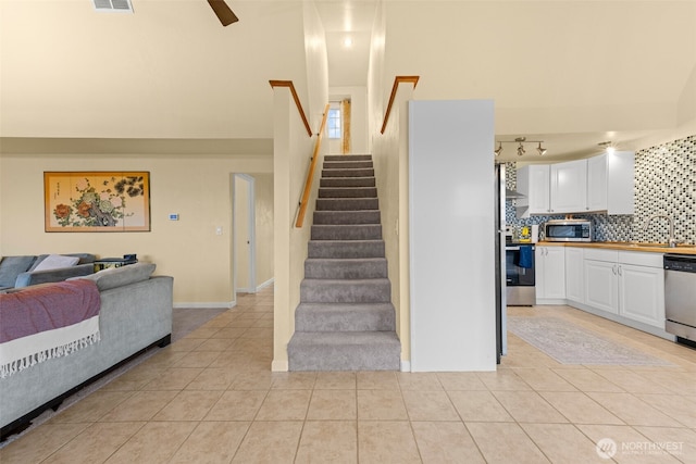 1291 Channel Ave SW, Ocean Shores, WA 98569 - stairway featuring tile patterned flooring and a high ceiling