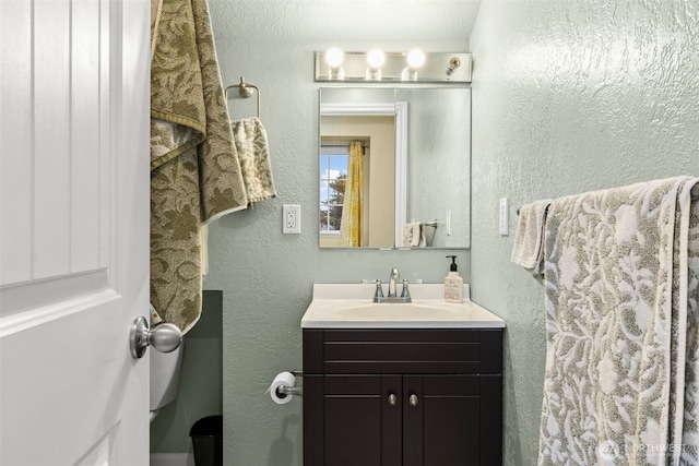 1291 Channel Ave SW, Ocean Shores, WA 98569 - bathroom featuring vanity, a textured wall, and toilet
