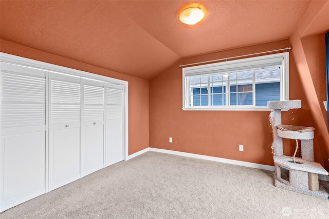 1291 Channel Ave SW, Ocean Shores, WA 98569 - unfurnished bedroom featuring vaulted ceiling, carpet, baseboards, a textured ceiling, and a closet