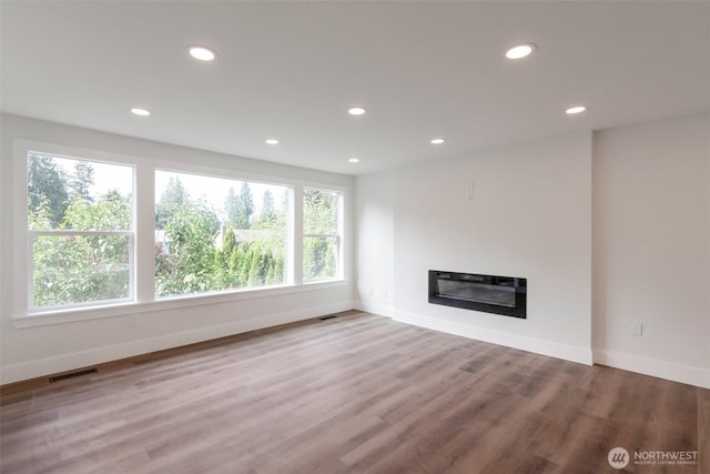 2015 172nd Pl SE, Bothell, WA 98012 - unfurnished living room with recessed lighting, baseboards, wood finished floors, and a glass covered fireplace