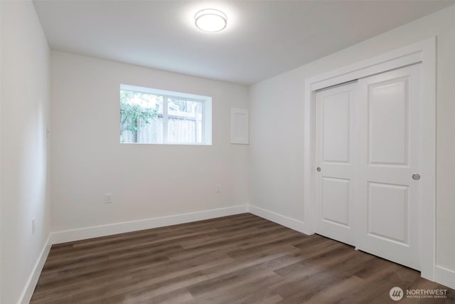 2015 172nd Pl SE, Bothell, WA 98012 - unfurnished bedroom with dark wood-type flooring, baseboards, and a closet