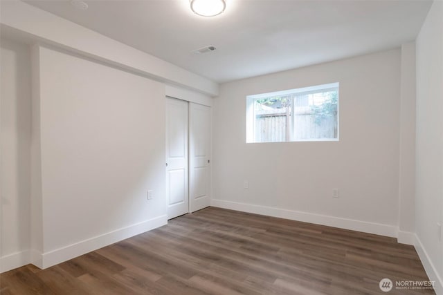 2015 172nd Pl SE, Bothell, WA 98012 - unfurnished bedroom with wood finished floors, baseboards, and a closet